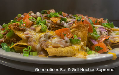A plate of nachos supreme from Generations Bar & Grill in Sherwood, featuring melted cheese and fresh toppings.